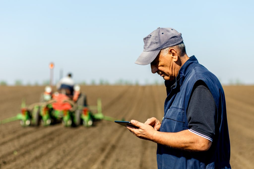 Senior Farmer Looking At Tablet Integrity Consulting Solutions